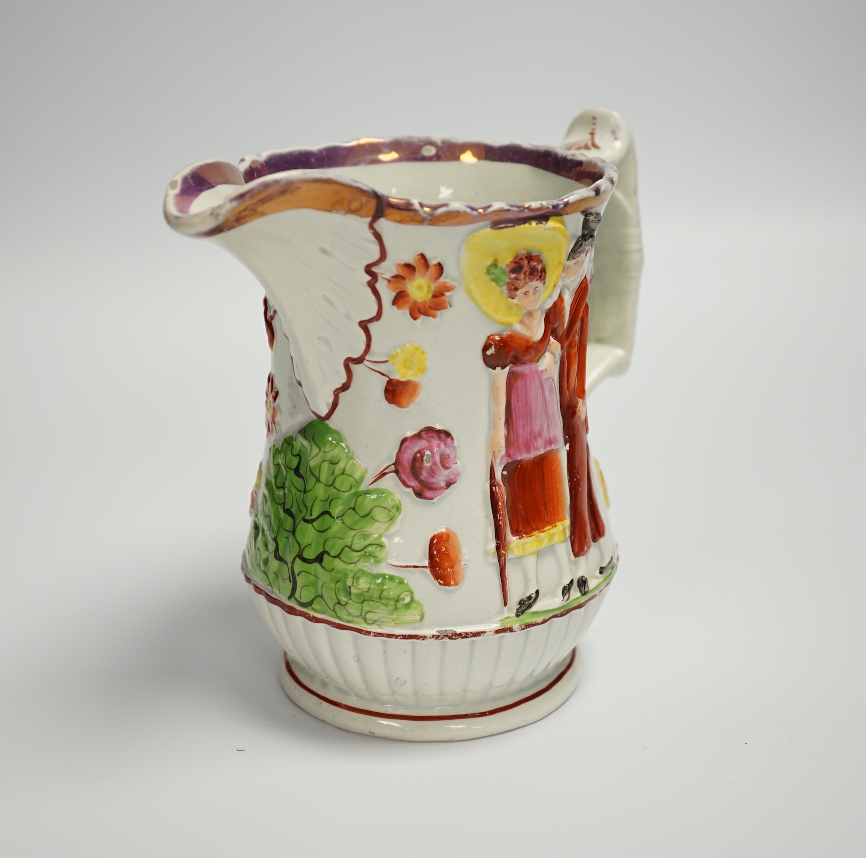 A relief moulded 19th century Staffordshire pearlware jug, 15cm high